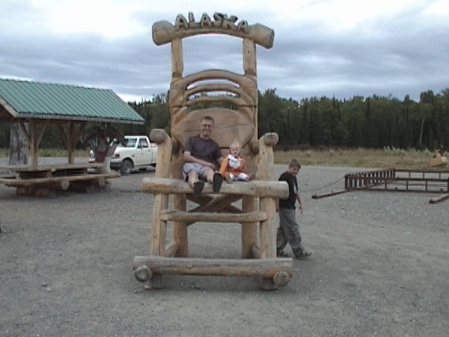 Lilli in the big chair with uncle Nick.JPG