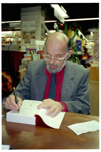 Allen Ginsberg signing his book