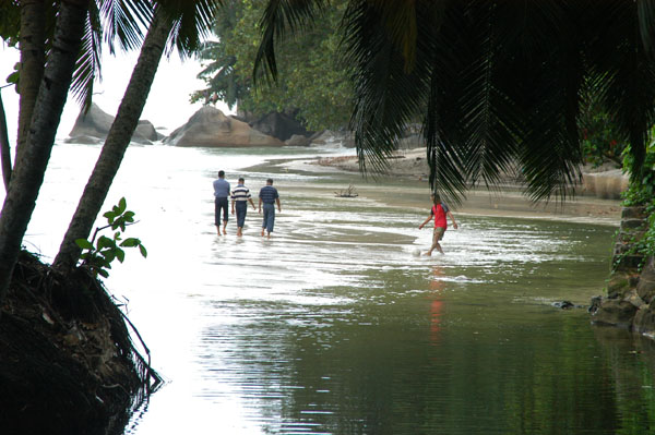 Wading through the water at Beau Vallon