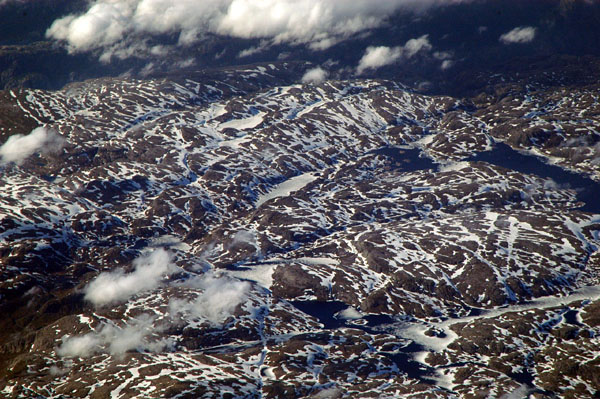 Snowy Norwegian highlands east of Lysenfjorden in June