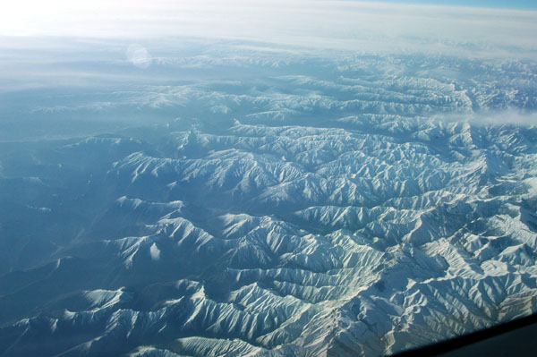 The high peaks of the Himalaya fall behind entering western China