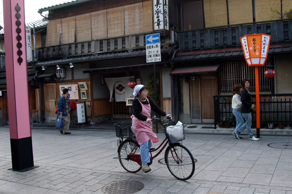 Cyclist passing through Gion