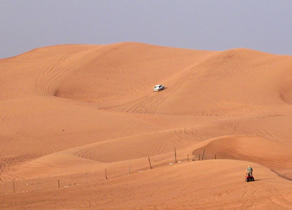 Jan on the quad bike while a jeep climbs the Big Red Dune