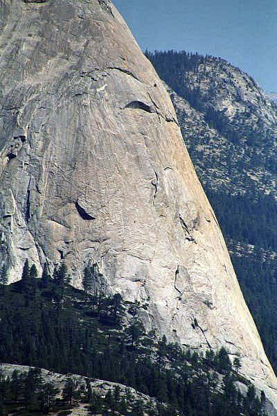There's a tiny climber on the side of Half Dome