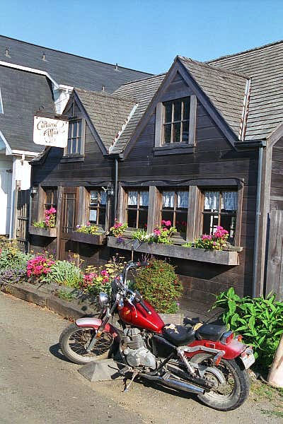 Motorcycle and an old clapboard house