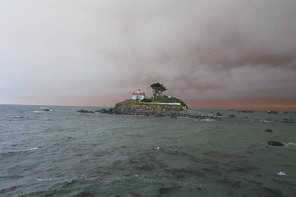 Lighthouse off Crecent City, California with the smoke of huge Oregon forest fires