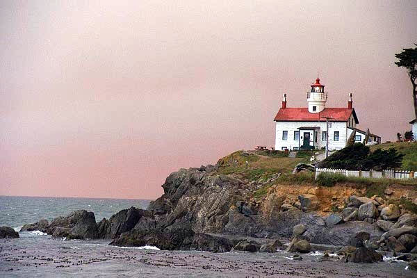 Smoke from massive Oregon forest fires over the lighthouse of Crescent City, California