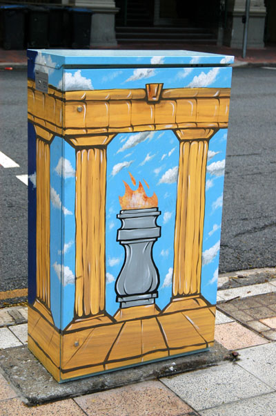 Painted utility box with the war memorial's eternal flame