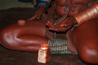 She shows us the ocre powder Himba woman use for their reddish color