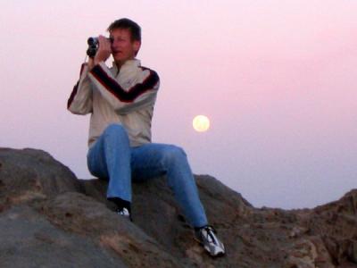 Ralph filming sunset on the cliffs at Lüderitz with the moon rising