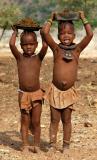 Himba children collecting manure