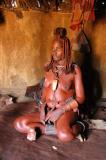 Himba woman in a hut