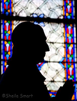 Statue silhouette at Notre Dame cathedral