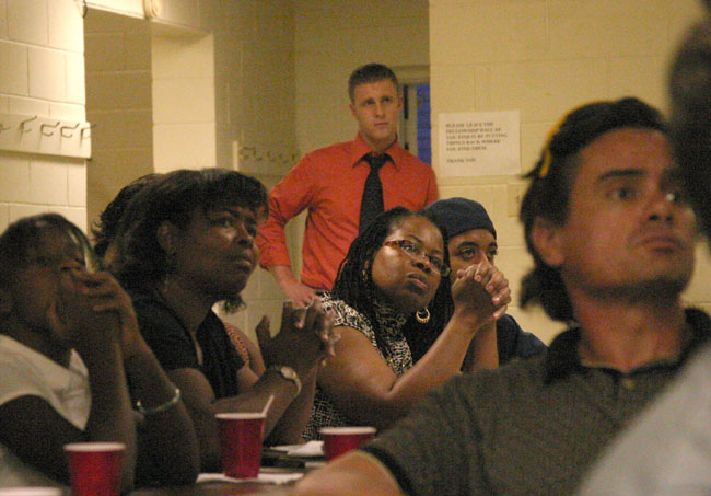 looking on while others listen