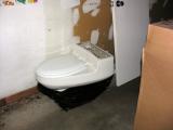 The toilet and interior door, stored for reinstallation