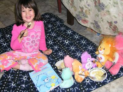 Sarah feeding her Care Bears some eggs